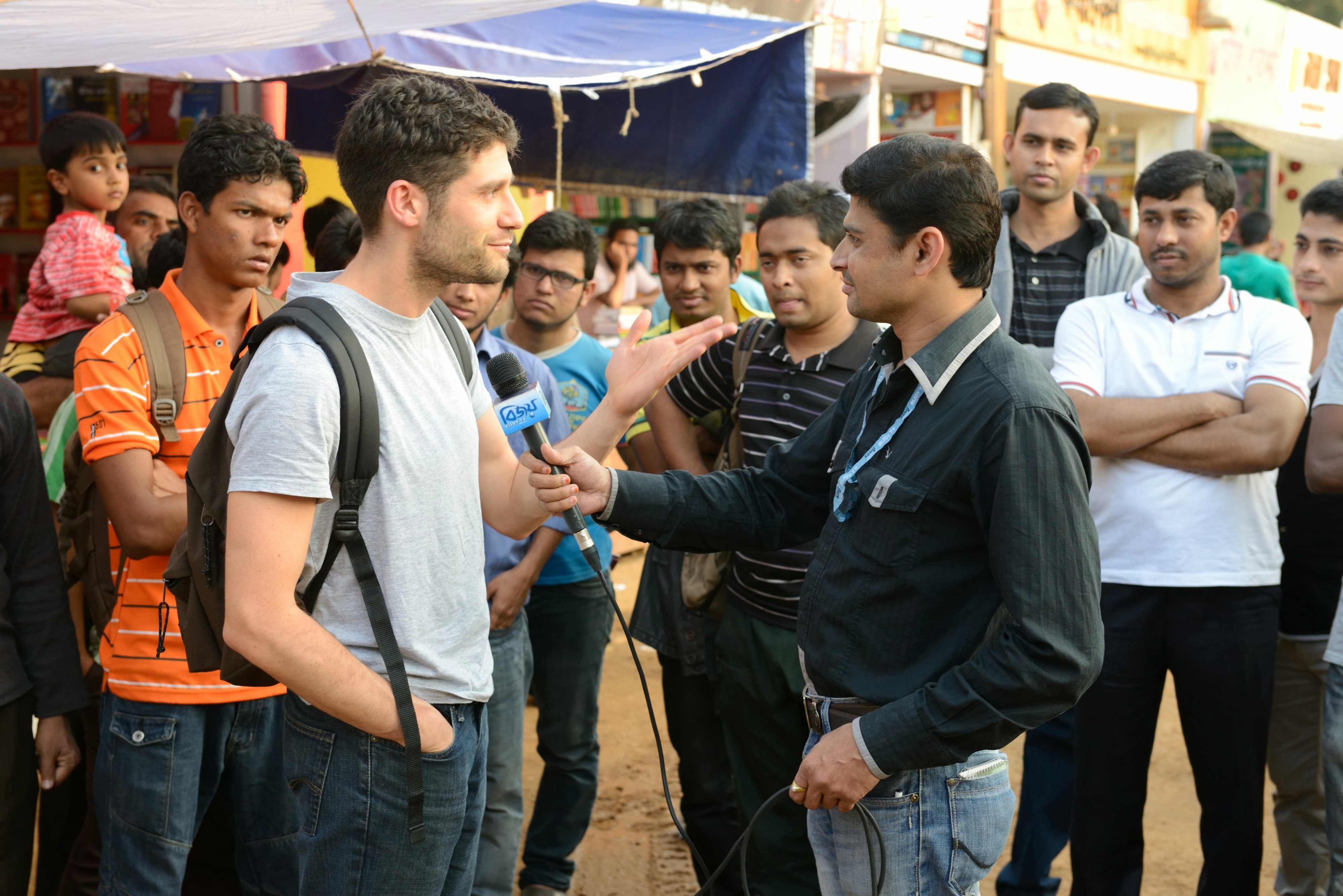 Nicola Trezzi talking to a news reporter in Dhaka, Bangladesh. Photo by Josh Tonsfeldt