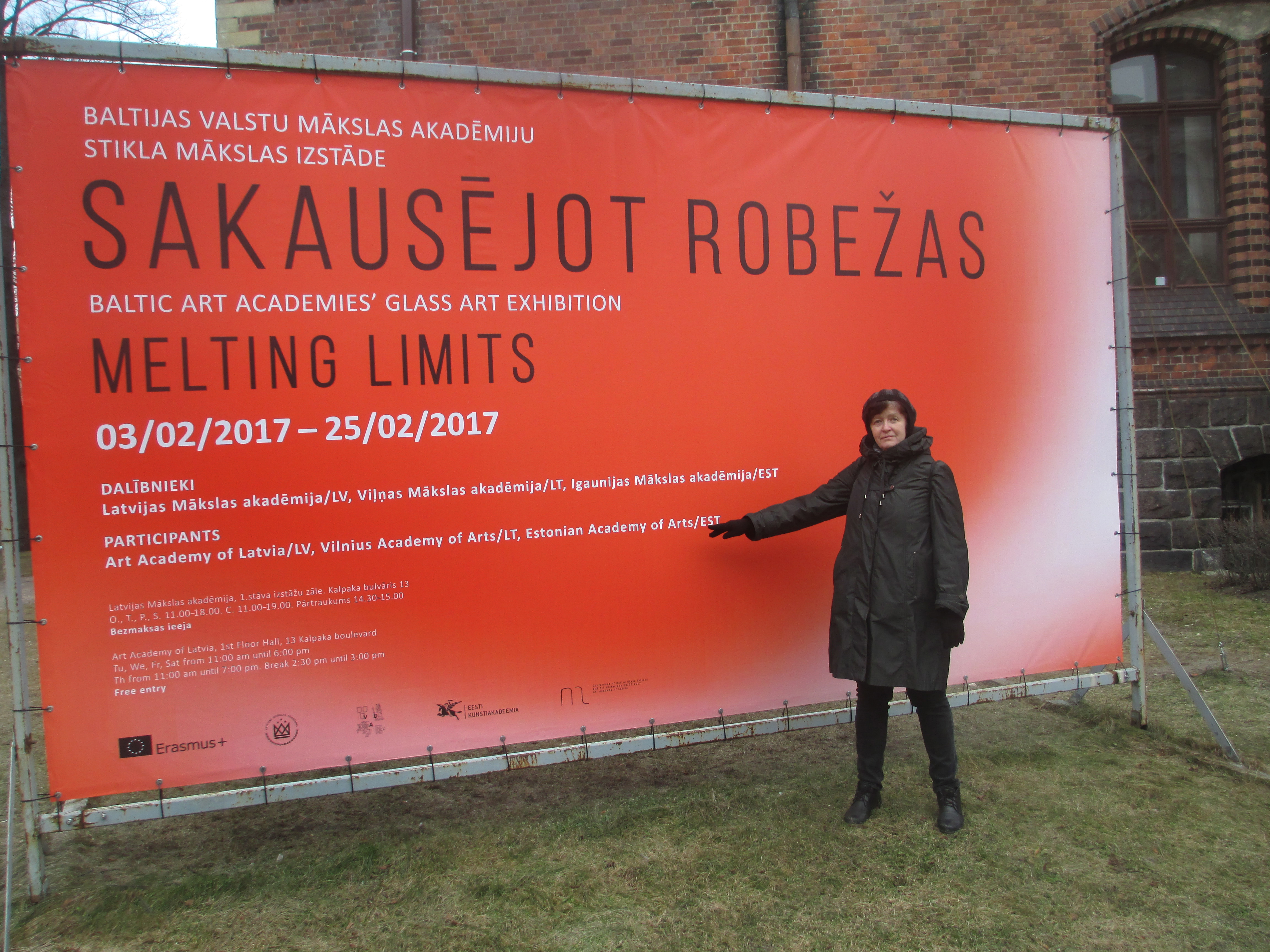 Professor Mare Saare from the Department of Glass Art with the exhibition banner