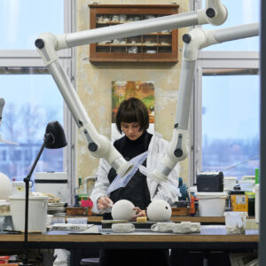 Student Mariann Hendrikson casting and sanding a lamp form. AEGLUS – Collaboration project with Estoplast. Supervisors Maria Pukk, Heikki Zoova, Karin Kalman. Photo: Valdek Laur. 2022