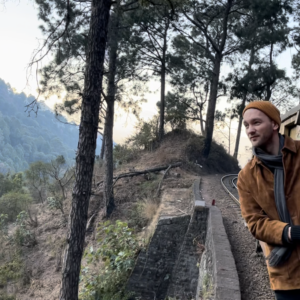 3. Art Historian Marten Esko leans out of Kalka-Shimla Express, a UNESCO World Heritage train, in the foothills of the Himalayas